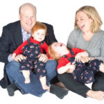 Family portrait taken in studio with white backdrop